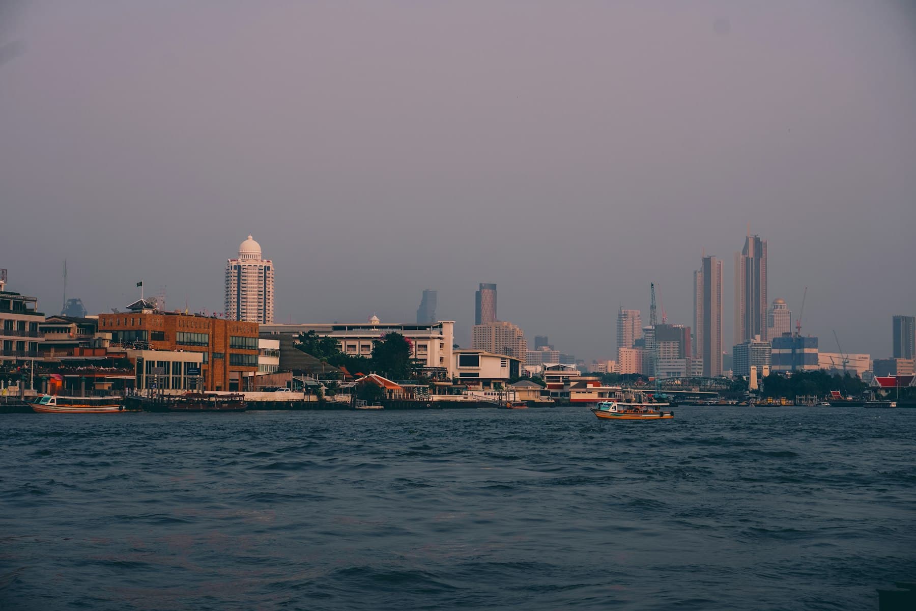 Bangkok skyline over the river at sunset